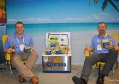 Matt Wentzel and Will Ison with Earth Source Trading enjoy a beer with Corona branded limes at the beach.